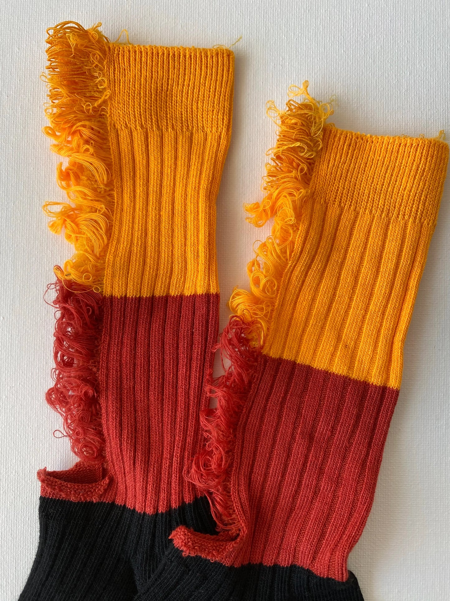 Closeup of unisex crew sock in orange and black colour leg and cuff