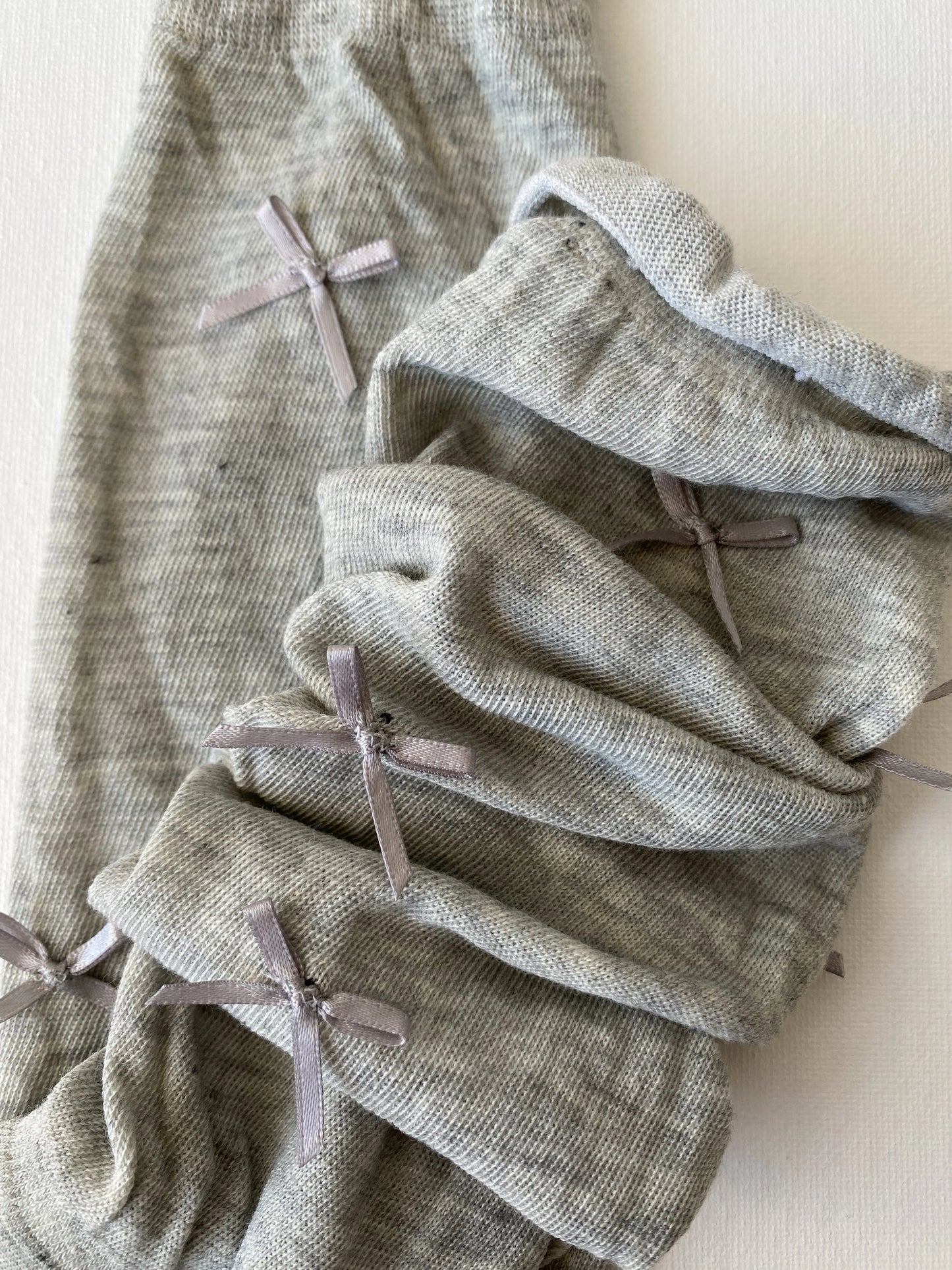 Closeup of slouched bow mid calf crew sock in moody grey colour slouching leg details