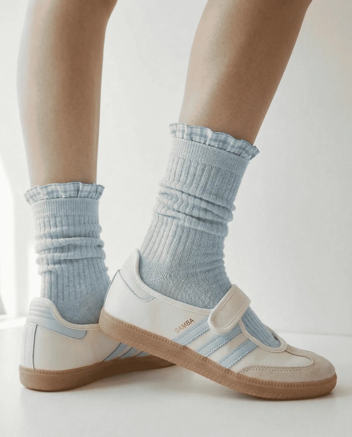 Closeup of Grey Checked Ruffle Crew Socks by Sock the Luck Up. Combed cotton ribbed socks with blue gingham trim and white sn