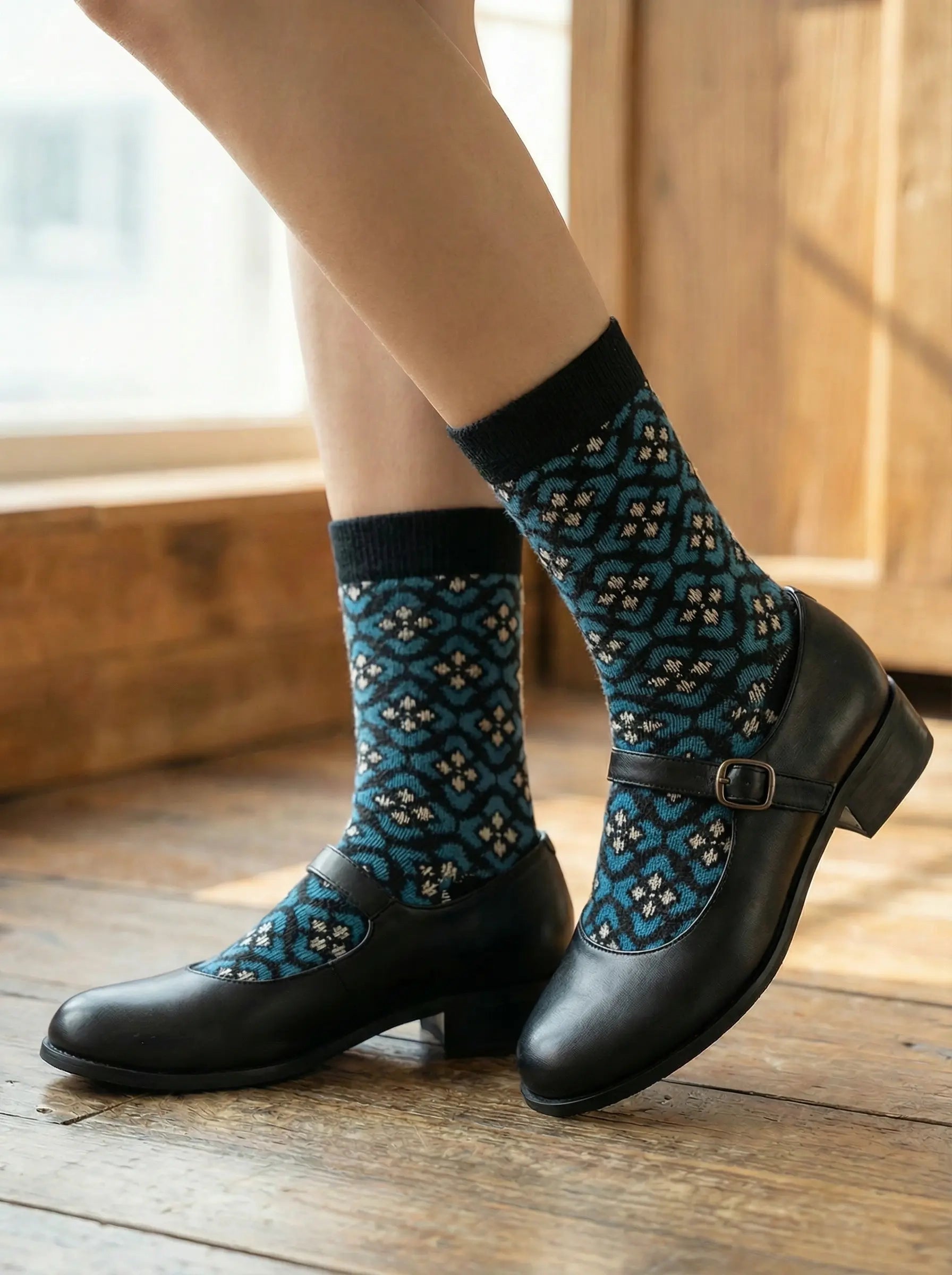 Heritage diamond crew sock in black and blue colours with black Mary Janes on wooden floor.