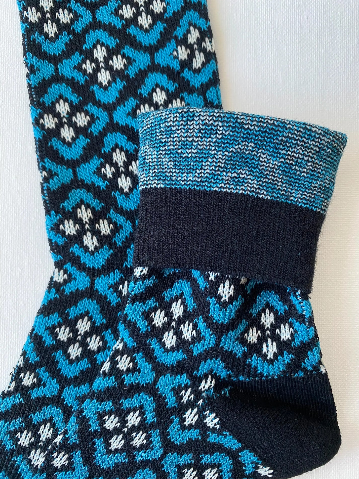 Closeup of the cuff and double knit construction of the heritage diamond crew sock in black and blue colours 