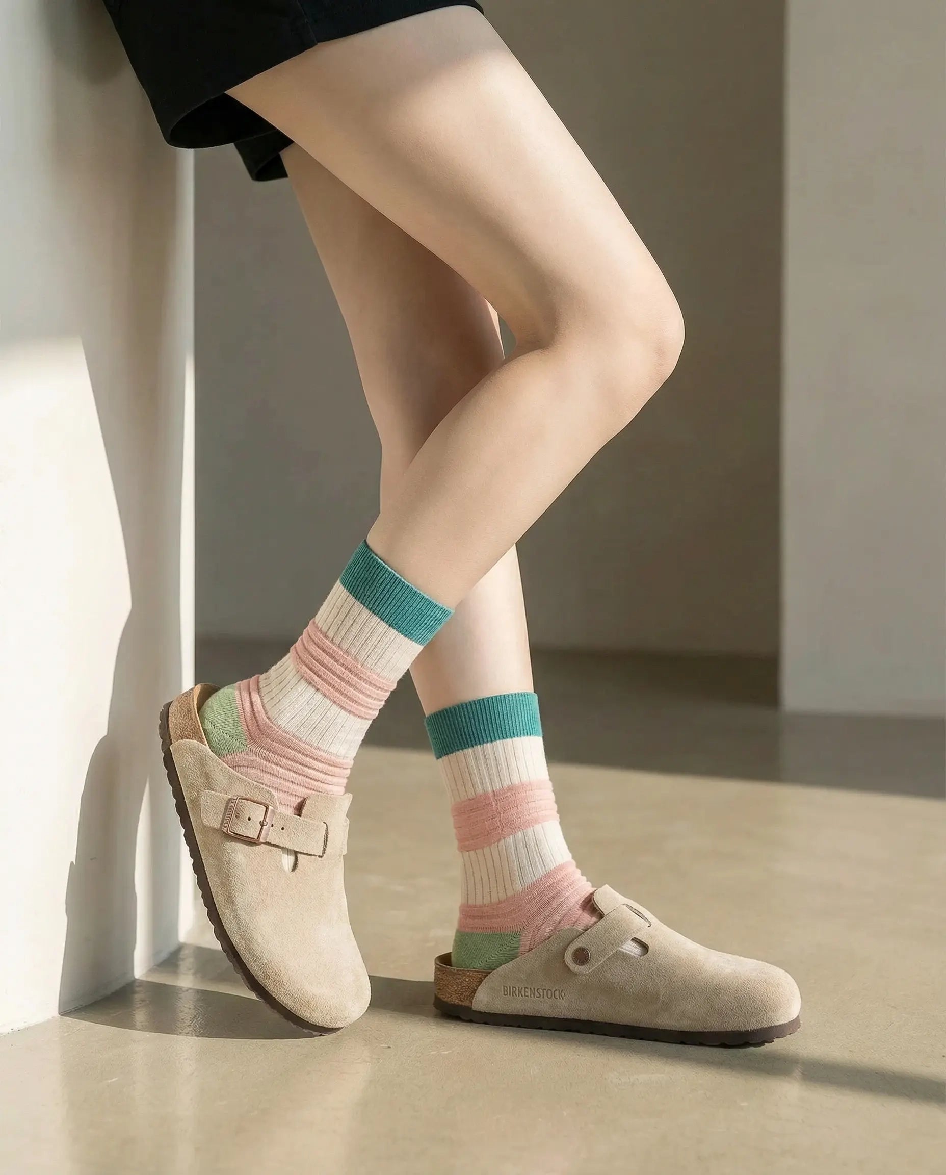 Closeup of high contrast pleated crew sock in pink and cream colours with beige slip-on flats