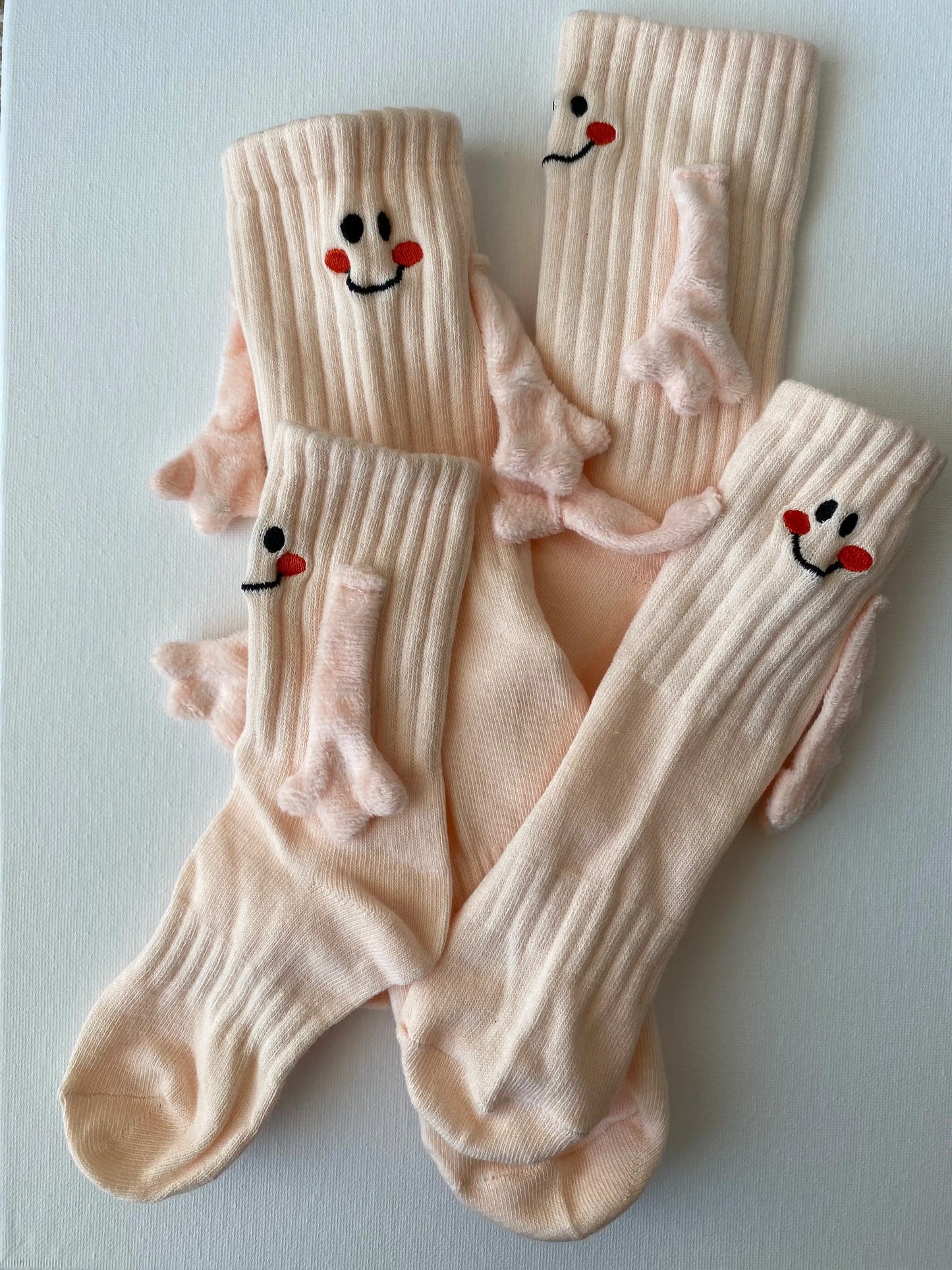 Closeup of magnetic smiley face family crew sock in beige colour entire set