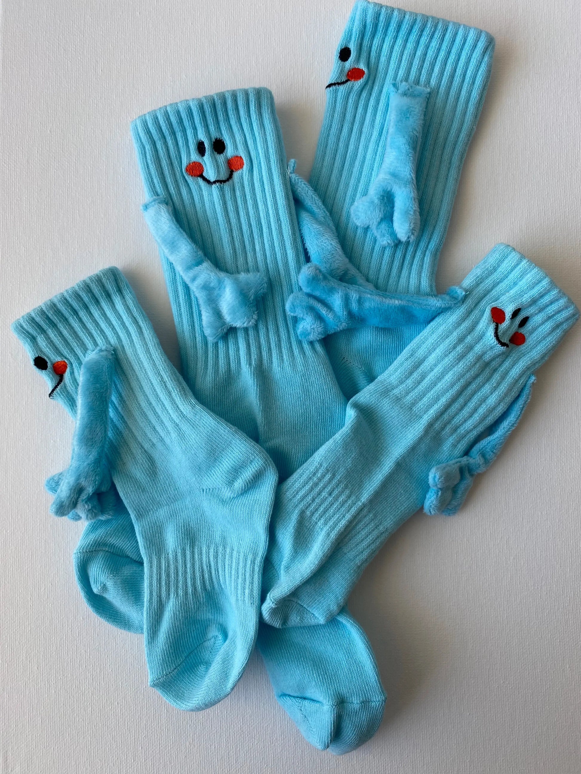 Closeup of magnetic smiley face family crew sock in blue colour entire set