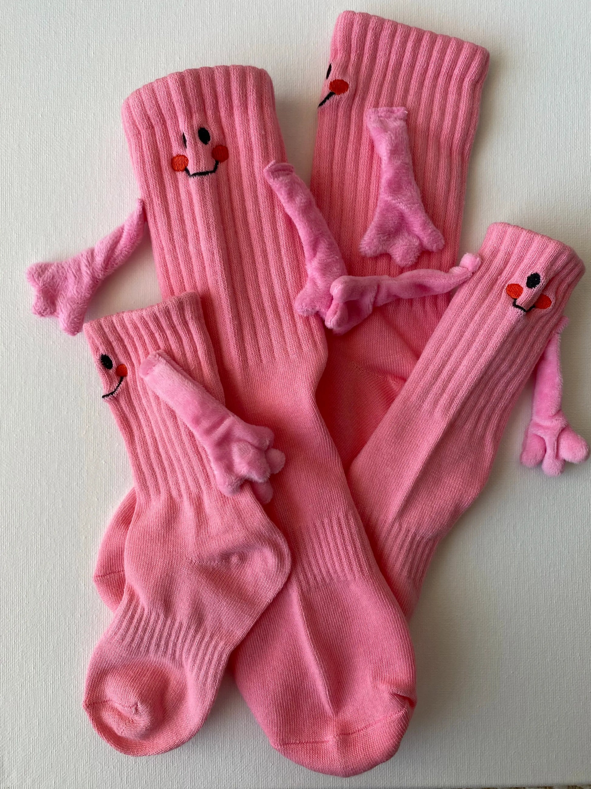 Closeup of magnetic smiley face family crew sock in pink colour entire set