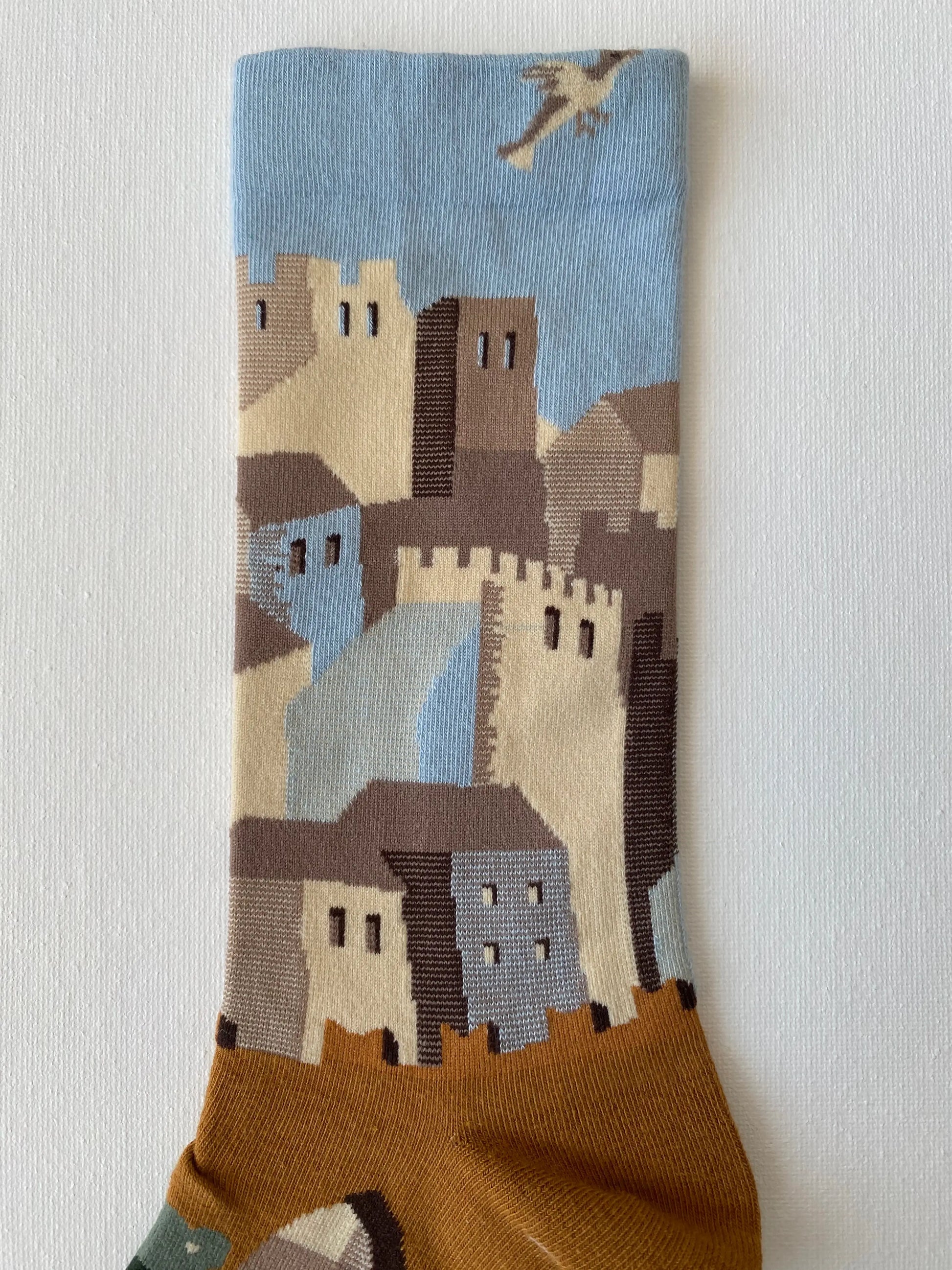 Close up of painted lost city unisex crew sock leg by Sock the Luck up AU