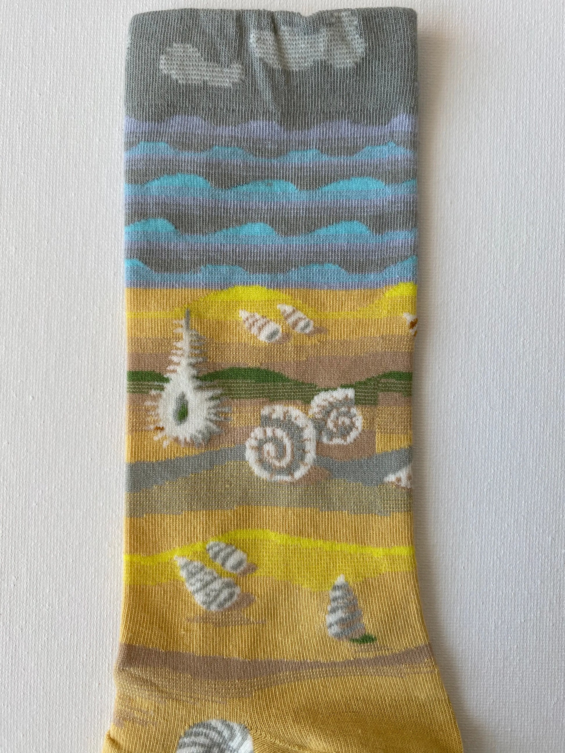 Close up of painted shells unisex crew sock leg by Sock the Luck up AU