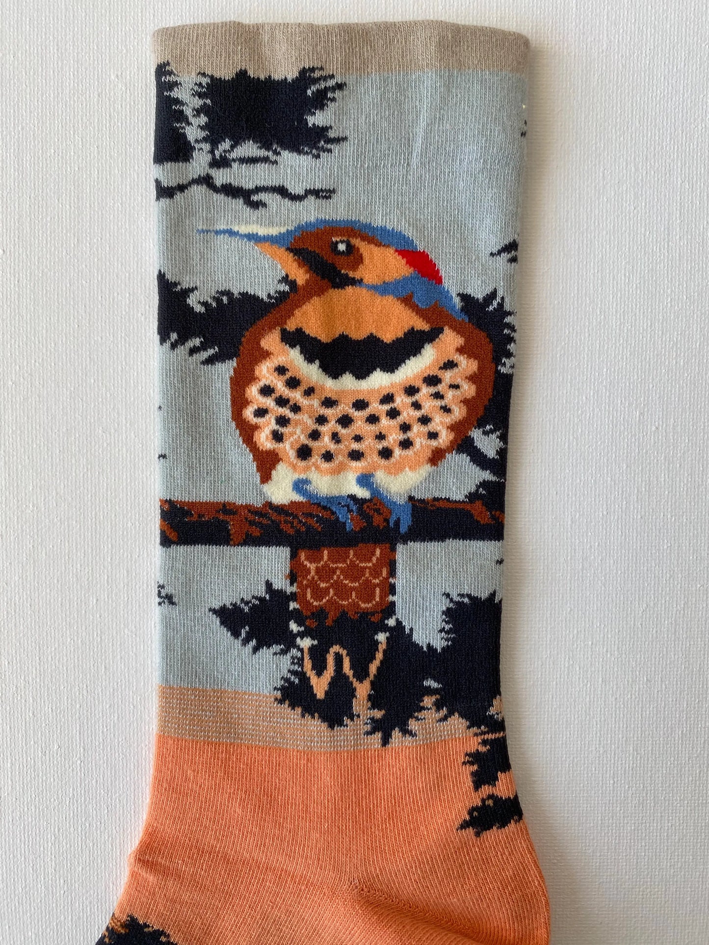 Close up of painted songbird unisex crew sock leg by Sock the Luck up AU