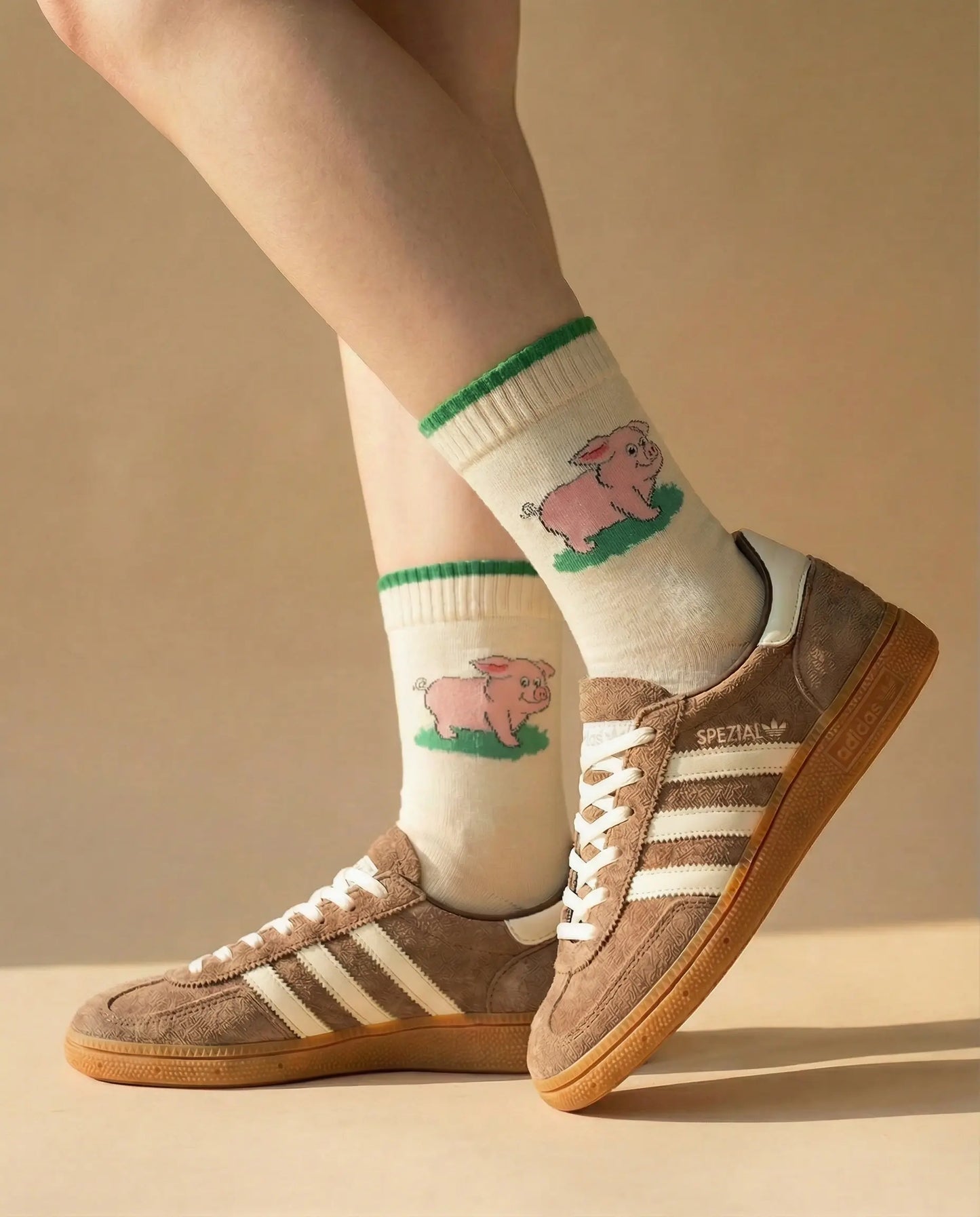 Closeup of Piggy Print Crew Sock in green colour try-on with brown suede sneakers