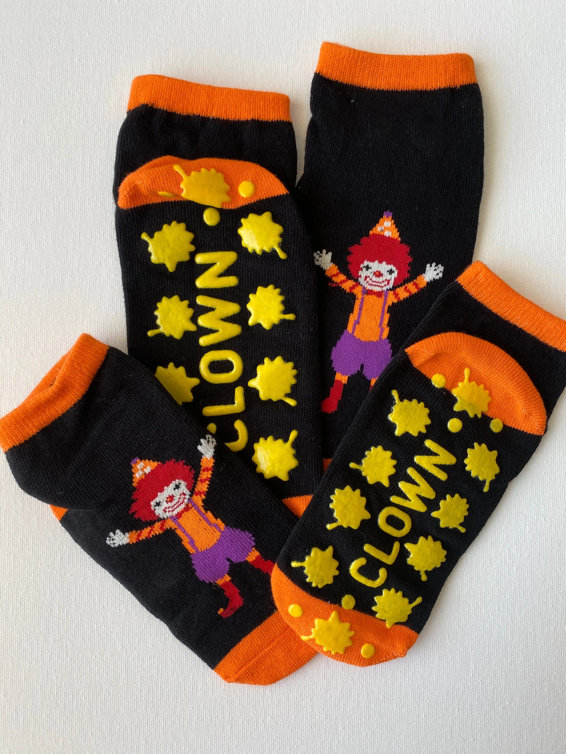 Closeup of silly clown family grip sock in orange colour entire set