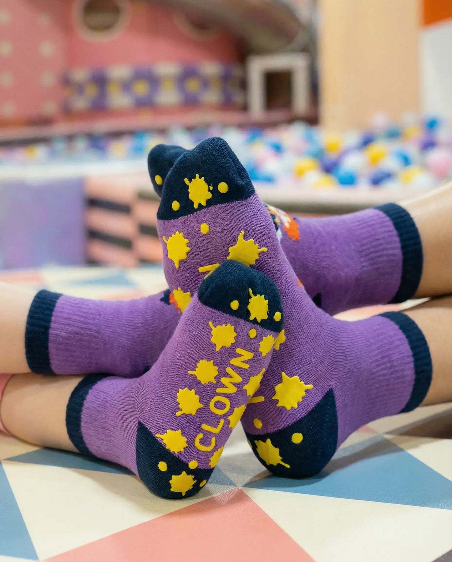 Tryon of silly clown family grip sock in purple colour in indoor playground