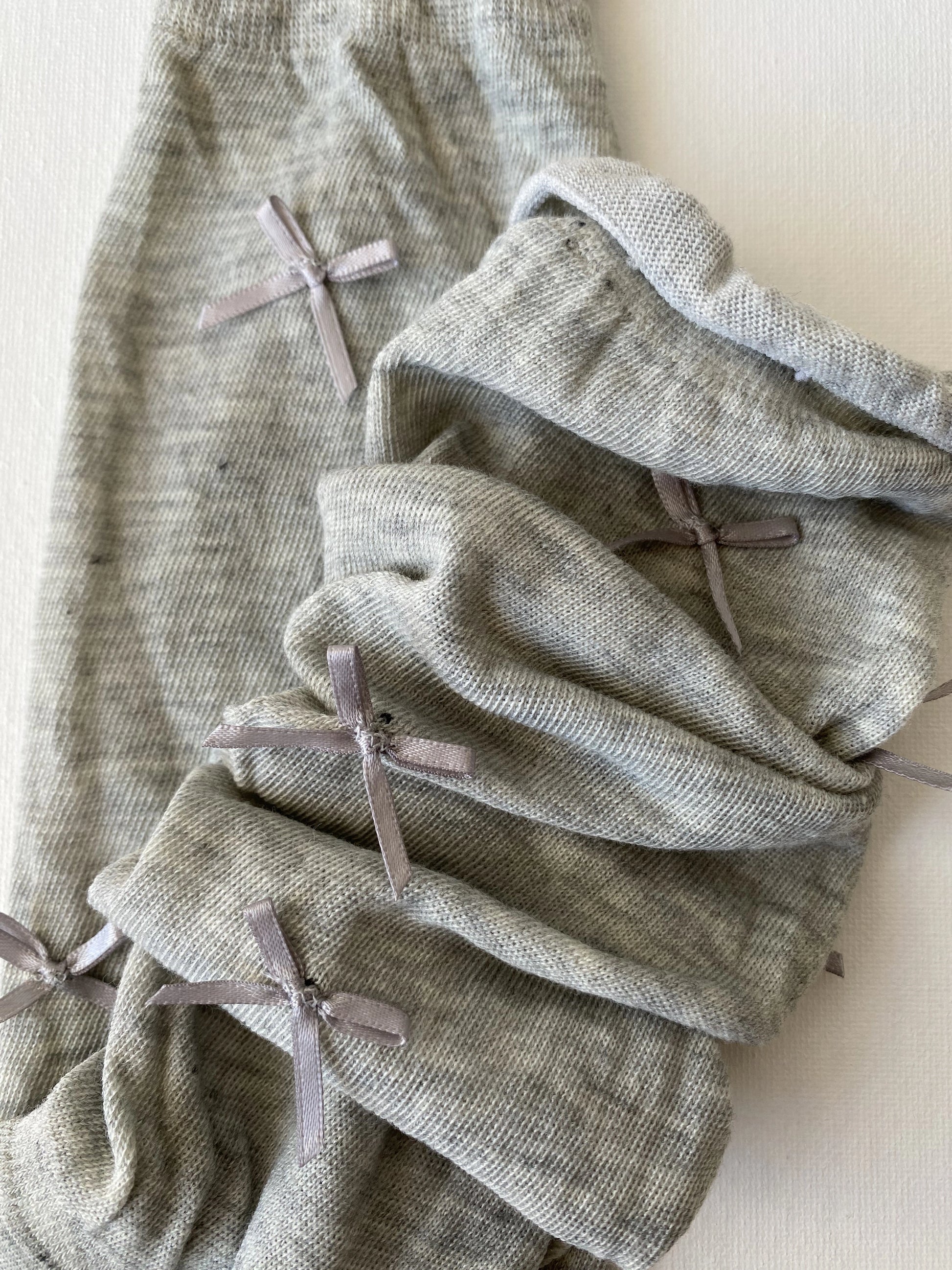Closeup of slouched bow mid calf crew sock in moody grey colour slouching leg details