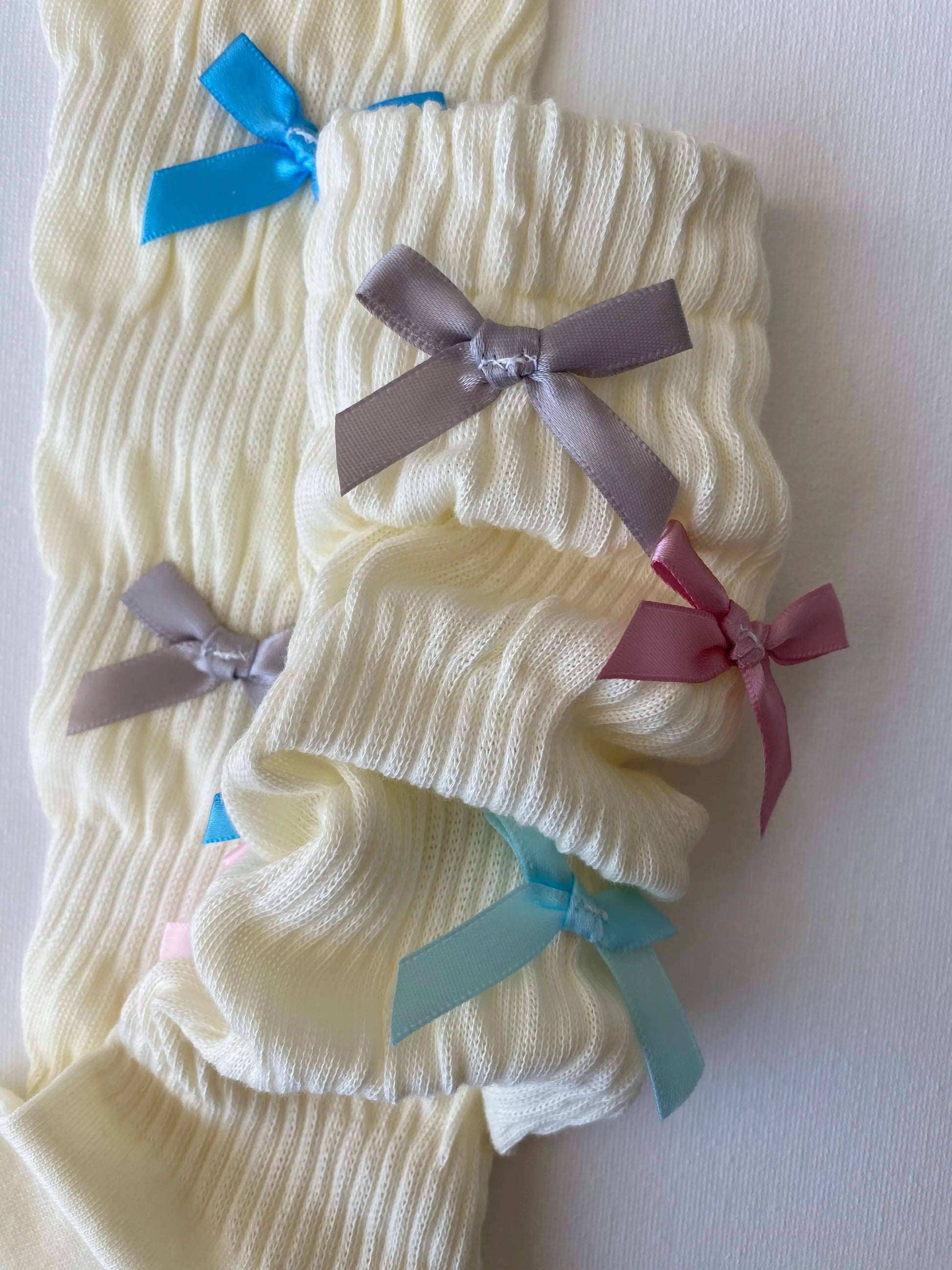 Closeup of slouched rainbow bow mid calf crew sock leg slouching details