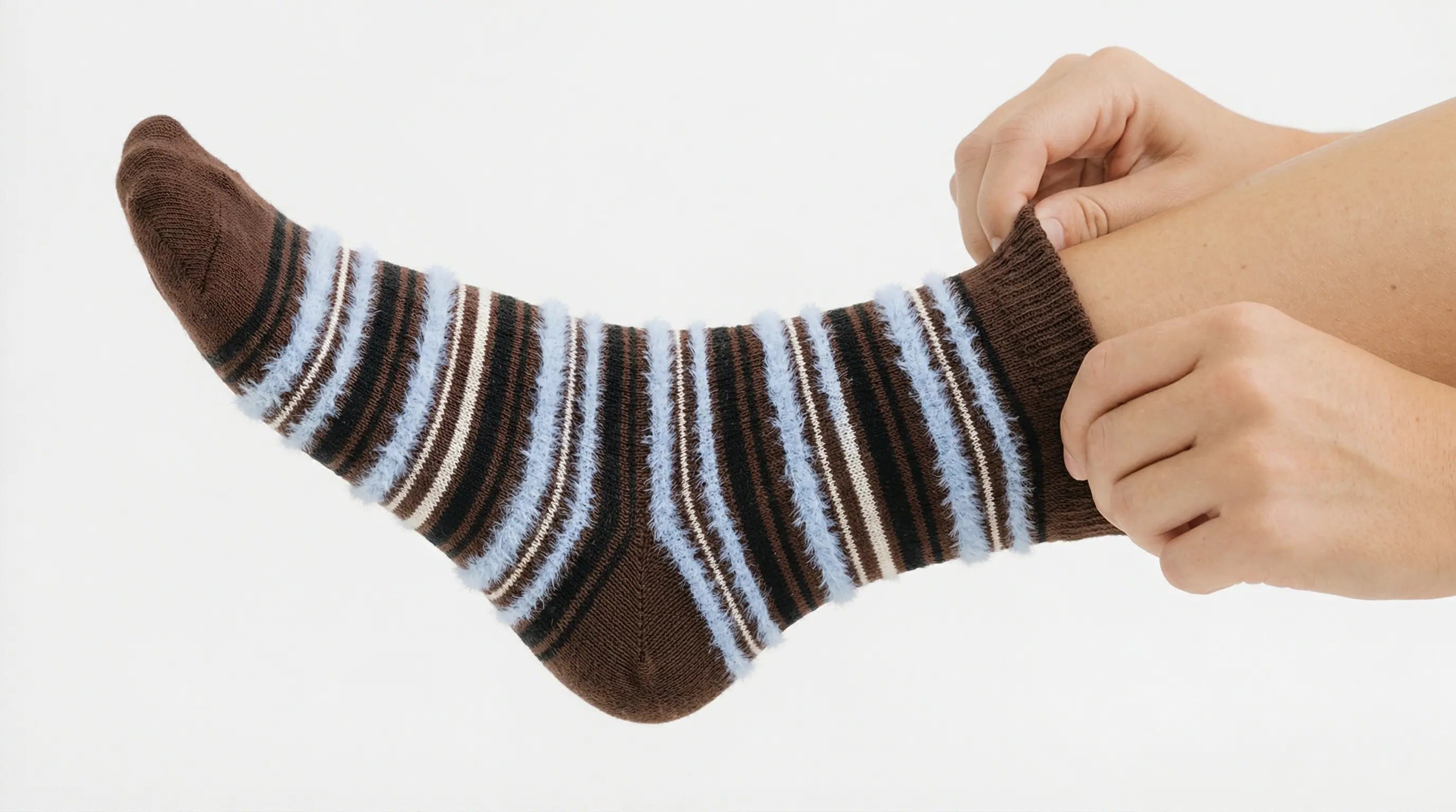 Close-up of someone putting on a sock, demonstrating the importance of a proper fit for comfort. Visit our size guide for measurements